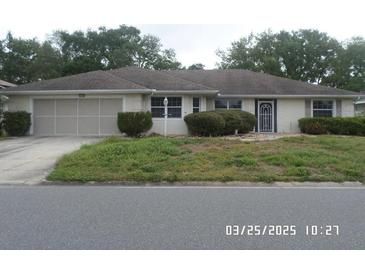 Charming single story home with a well-manicured front yard and attached garage at 21708 Royal St Georges Ln, Leesburg, FL 34748