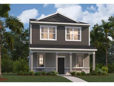 Charming two-story home featuring stone accents, inviting porch, and dark gray wood siding at 426 Belmond Dr, Debary, FL 32713
