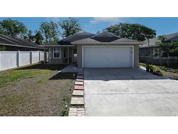 Charming single-story home featuring an attached two-car garage and well-maintained front yard at 443 S Observatory Dr, Orlando, FL 32835
