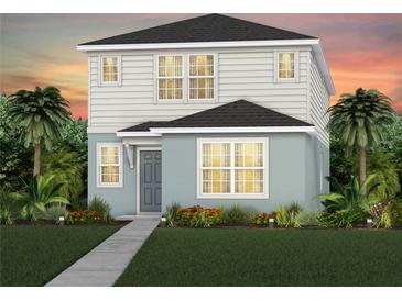 Charming two-story home with a well-manicured lawn, complemented by tropical landscaping and a picturesque sunset backdrop at 5044 Starling Bird Ln, St Cloud, FL 34771