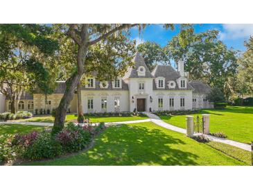 Stunning exterior elevation showcasing manicured landscaping and a custom walkway to the front door at 5100 Cranes Point Ct, Orlando, FL 32839