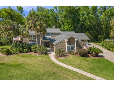 Beautiful two story home with stone accents, mature trees and landscaping at 677 Benitawood Ct, Winter Springs, FL 32708