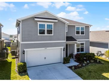Stylish two-story home with landscaped front yard and attached two-car garage in a great neighborhood at 7649 Ragusa Way, Clermont, FL 34714
