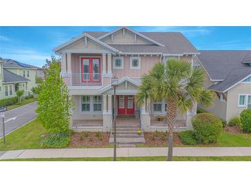Charming two-story home with red doors, a manicured lawn, and a mature palm tree in a desirable neighborhood at 7831 Dausset St, Orlando, FL 32827