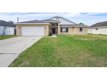 Inviting single-Gathering home boasts a two-car garage and a well-maintained lawn at 117 Honeywood Dr, Kissimmee, FL 34743