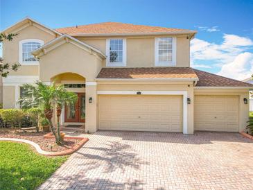 Charming two-story home featuring a 3-car garage and a well-manicured front yard at 2145 Plantation Oak Dr, Orlando, FL 32824