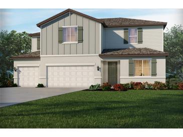 Two-story home with a two car garage, neutral color palette and manicured front yard at 2356 Citrus Bloom Dr, Bartow, FL 33830