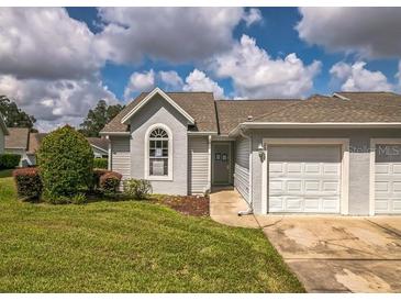 Charming home features a well-maintained lawn and attached one car garage at 2503 Se 18Th Cir, Ocala, FL 34471