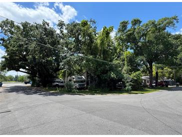 Overgrown property featuring lush, mature trees and vegetation offers privacy and a natural setting at 2520 Raehn St, Orlando, FL 32806