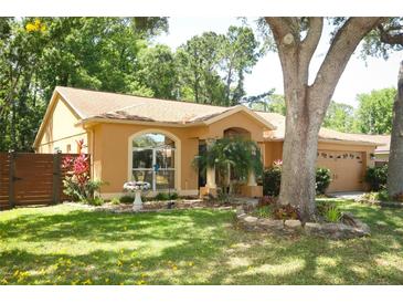 Charming single-story home featuring a landscaped yard and a side-entry garage at 304 Little Springs Ln, Longwood, FL 32750