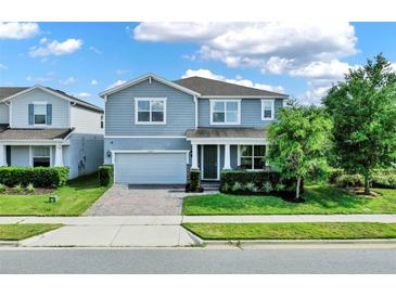 Charming two-story home with a well-manicured lawn and inviting front entrance at 3259 Buoy Cir, Winter Garden, FL 34787