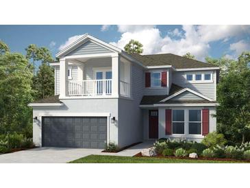 Charming two-story home featuring a front porch, balcony, and a two-car garage at 5253 Quillback Ln, St Cloud, FL 34771