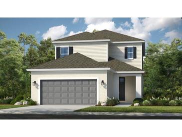 Charming two-story home showcasing a modern exterior, manicured landscaping, and a two-car garage at 1030 Teal Creek Dr, St Cloud, FL 34771