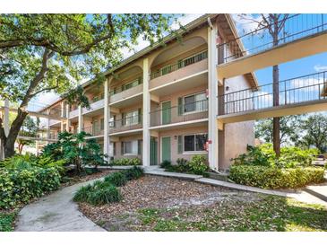 Charming condo building with multiple levels, exterior walkways, and lush landscaping at 109 Oyster Bay Cir # 150, Altamonte Springs, FL 32701