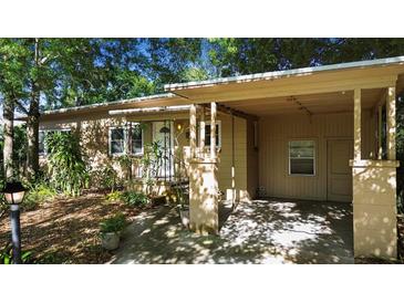 Charming single-story home with a covered carport, mature landscaping, and a welcoming front porch at 1207 Cole Rd, Orlando, FL 32803