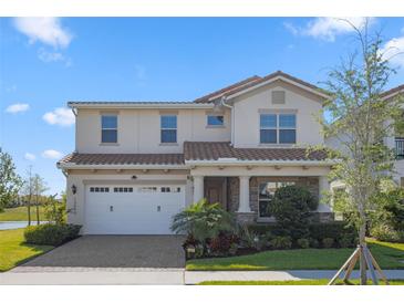 Charming two-story home with a well-manicured lawn, beautiful landscaping, and a two-car garage at 13090 Bromborough Dr, Orlando, FL 32832