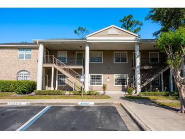 Attractive two-story condo building with stairs, columns, and reserved parking at 133 Reserve Cir # 109, Oviedo, FL 32765