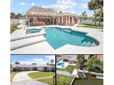 Inviting outdoor space featuring a large pool, tiki bar, and well-maintained landscaping in a waterfront property at 151 Sea Isle Cir, South Daytona, FL 32119