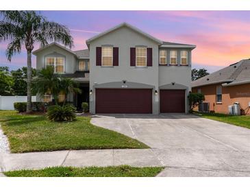 Charming two-story home featuring a two-car garage, landscaped yard, and a welcoming facade at 289 Magnolia Park Trl, Sanford, FL 32773