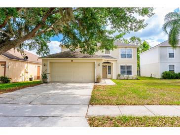 Charming two-story home with a manicured lawn and a two-car garage at 4113 Stonefield Dr, Orlando, FL 32826