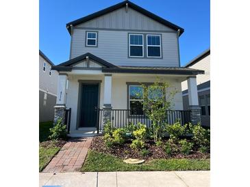 Charming two-story home with a covered front porch and neatly landscaped front yard at 4716 Homestead Trl, St Cloud, FL 34772