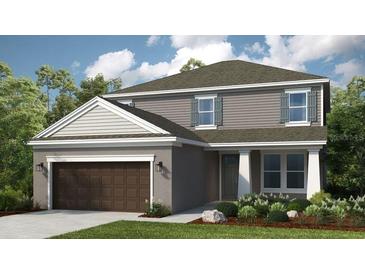 Charming two-story home features a neutral color palette, a two car garage and a welcoming front entrance at 5229 Quillback Ln, St Cloud, FL 34771