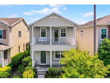 Charming two-story home with a covered porch and manicured landscaping at 5711 Hamlin Groves Trl, Winter Garden, FL 34787