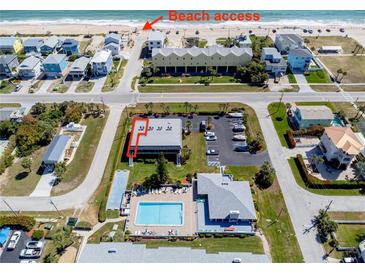 An aerial view showcasing beach access and community pool and parking at 865 Ladyfish Ave # C104, New Smyrna Beach, FL 32169