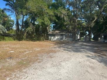 Quaint single-story home nestled among mature trees, offering a serene and private setting at 91 N Triplet Lake Dr, Casselberry, FL 32707