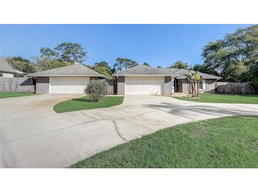 Charming home boasts a two-car garage and well-manicured lawn at 1155 Collins Ave, Orange City, FL 32763
