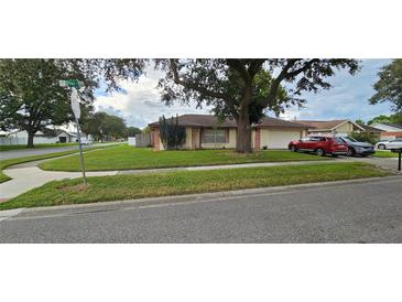 Charming single-story home featuring a well-manicured lawn and attached garage, offering comfort and convenience at 12144 Chive St, Orlando, FL 32837