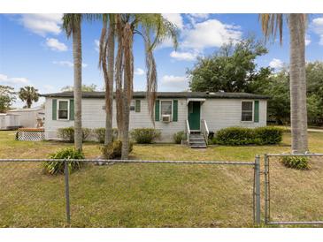 Charming single-story home featuring a quaint front yard and mature trees at 18600 Old Cheney Hwy, Orlando, FL 32820