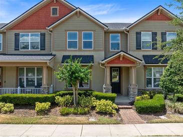 Charming townhouse featuring a well-manicured lawn and colorful exterior accents at 2638 Giardino Loop, Kissimmee, FL 34741