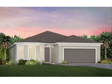 Charming single-story home with a two-car garage, green lawn, and lush landscaping at 2717 Serenity Meadow Dr, Kissimmee, FL 34744