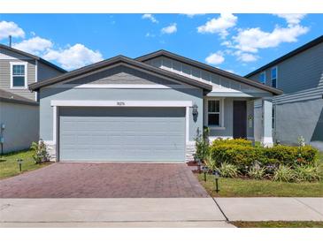 Charming single-story home with a two-car garage, brick driveway, and well-maintained landscaping at 30276 Armenia Rd, Leesburg, FL 34748