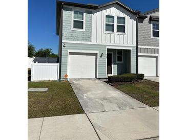 Charming two-story townhouse with an attached garage and well-maintained front yard at 366 Madison Dr, Davenport, FL 33837