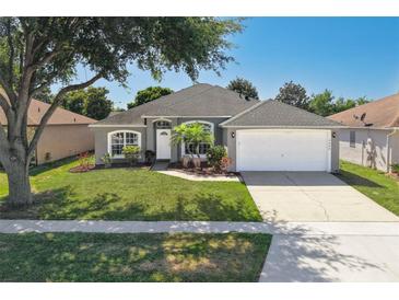 Charming single-story home with a well-manicured lawn and a two-car garage at 4008 Lakeside Reserve Ct, Orlando, FL 32810