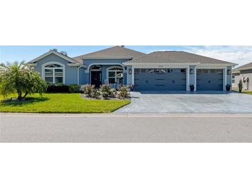 Charming single story home with a three car garage, inviting front yard and meticulous landscaping at 6328 Merhottein Loop, The Villages, FL 32163