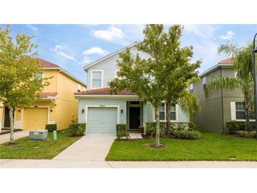 Charming two-story home with a well-maintained lawn and attached single car garage at 9004 Majesty Palm Rd, Kissimmee, FL 34747