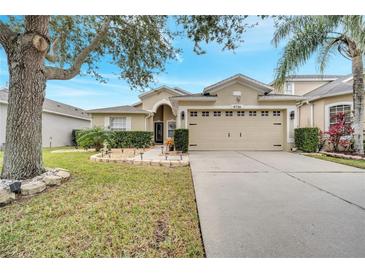 Charming single-story home with a spacious two-car garage, well-manicured lawn, and beautiful landscaping at 9736 Heron Pointe Dr, Orlando, FL 32832