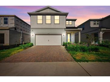 Charming two-story home with a brick driveway and lush landscaping at 10215 Park Estates Ave, Orlando, FL 32836
