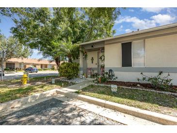 Charming single-story home featuring a cozy front yard with mature trees and a welcoming entrance at 1303 Azalea Way, Winter Garden, FL 34787