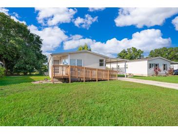 Charming single-story home featuring a wheelchair ramp and well-maintained lawn at 2650 Einwood Dr, Kissimmee, FL 34758