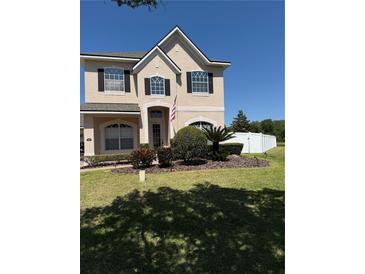 Charming two-story home featuring a well-manicured lawn and inviting curb appeal at 313 Tudor Spring Ct, Orlando, FL 32828