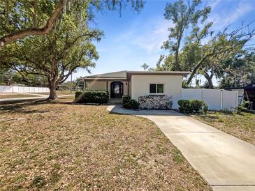 Charming single-story home with a well-maintained front yard, mature trees, and a welcoming entrance at 370 E Waldo St, Groveland, FL 34736