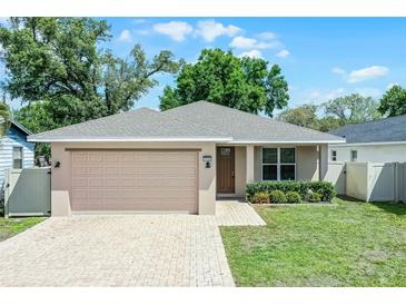 Charming single-story home with a well-manicured lawn, brick driveway, and an attached two-car garage at 3723 Broadway St, Gotha, FL 34734