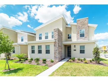 Beautiful two-story home featuring a stone column and well-manicured lawn at 4501 Target Blvd, Kissimmee, FL 34746