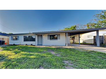 Charming single-story home with a well-maintained lawn and covered carport at 4510 Ravinnia Dr, Orlando, FL 32809
