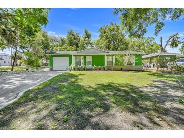 Charming single story home with a well-manicured lawn and an attached garage at 728 E Clifford Ave, Eustis, FL 32726