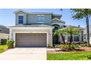 Charming two-story home features a two-car garage, well-maintained landscaping, and a welcoming entrance at 918 Emerald Green Ct, Kissimmee, FL 34746